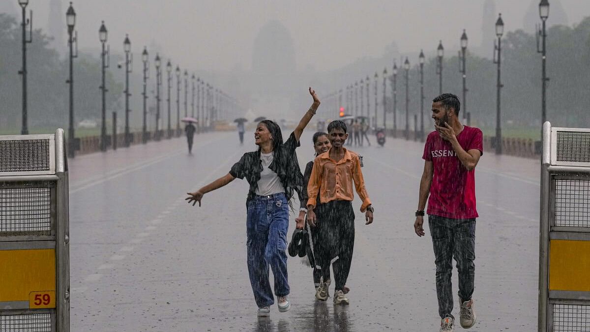 <div class="paragraphs"><p>People enjoy during rains, at Kartavya Path in New Delhi, Friday, September 13, 2024.</p></div>