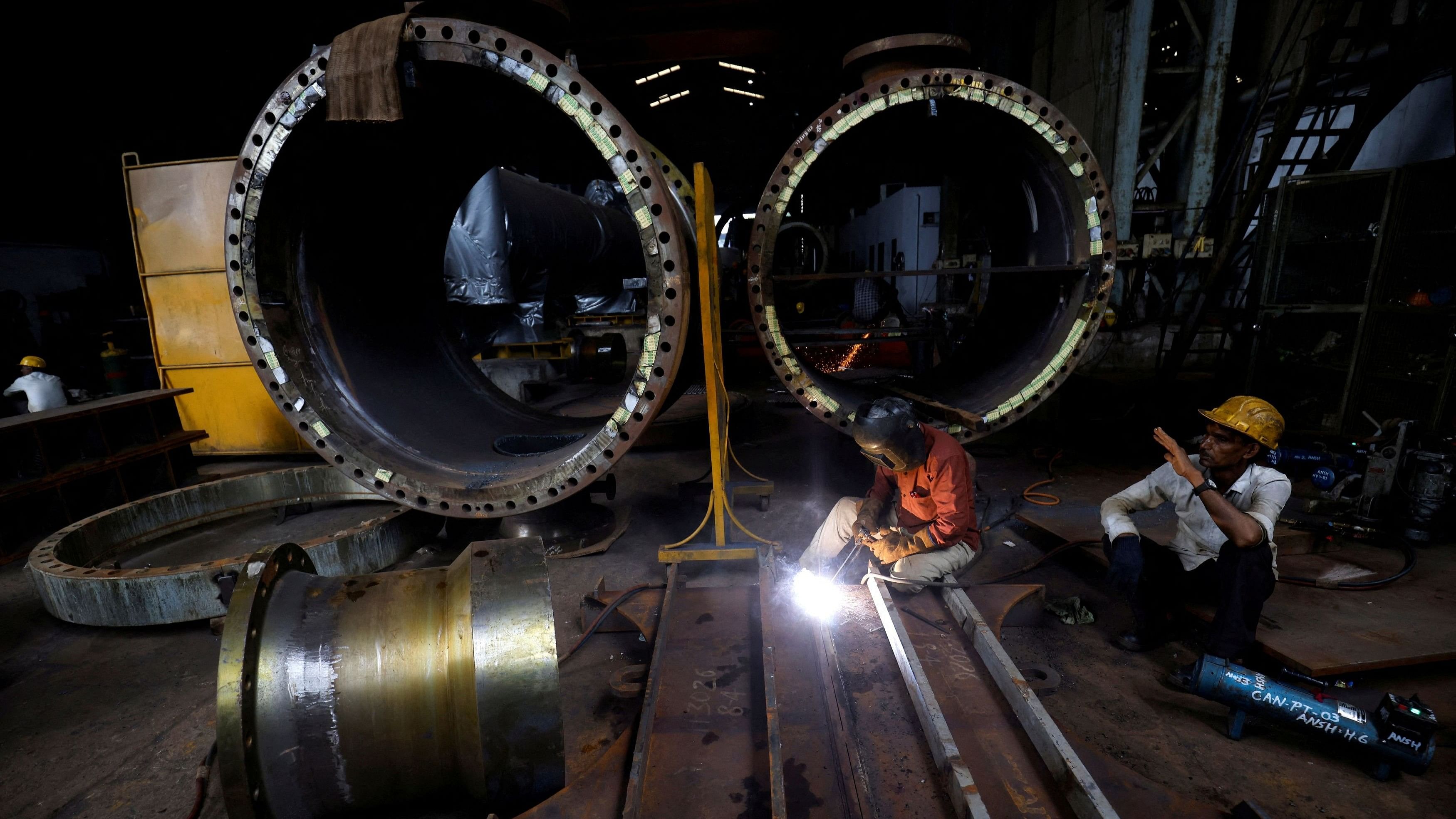 <div class="paragraphs"><p>A worker welds a cooling coil plate inside an industrial manufacturing unit on the outskirts of Ahmedabad, India </p></div>