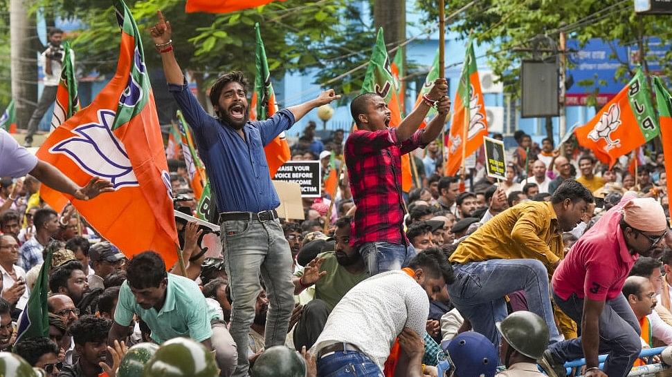 <div class="paragraphs"><p>BJP activists raise slogans during a protest march against alleged rape and murder of a trainee woman doctor at the RG Kar Medical College and Hospital, in Kolkata, Thursday, Aug 22, 2024.</p></div>