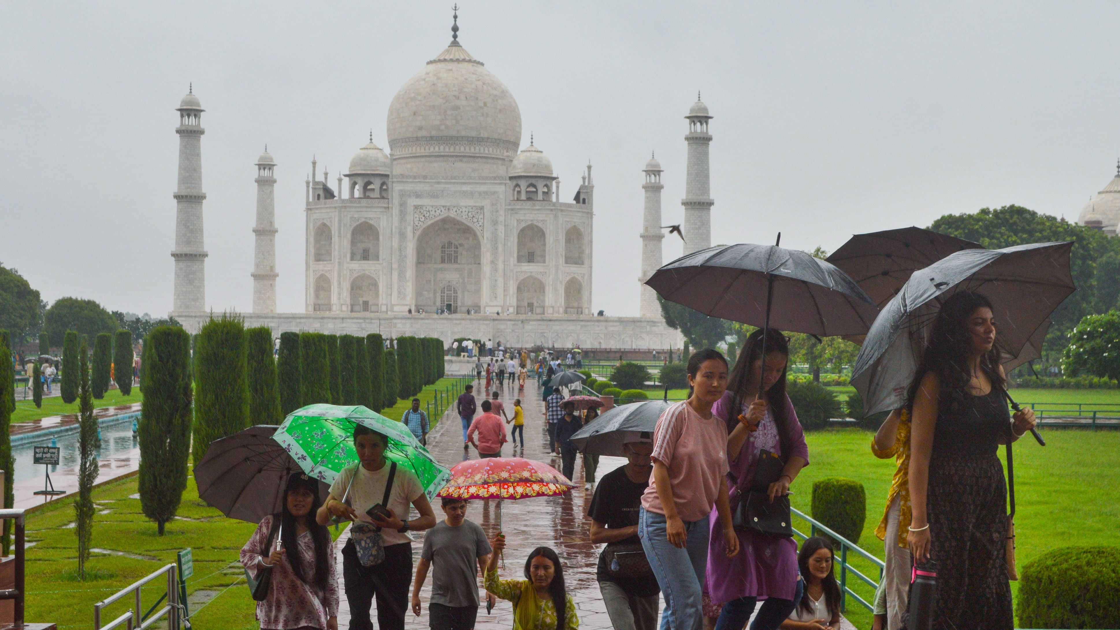 <div class="paragraphs"><p>Visitors at the Taj Mahal during rain, in Agra, Wednesday</p></div>