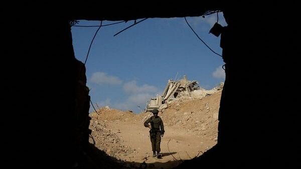 <div class="paragraphs"><p>An Israeli soldier walks towards the entrance to a tunnel leading to Egypt amid the ongoing conflict between Israel and the Palestinian Islamist group Hamas in the Gaza Strip, in the Philadelphi Corridor area in southern Gaza, September 13, 2024. </p></div>