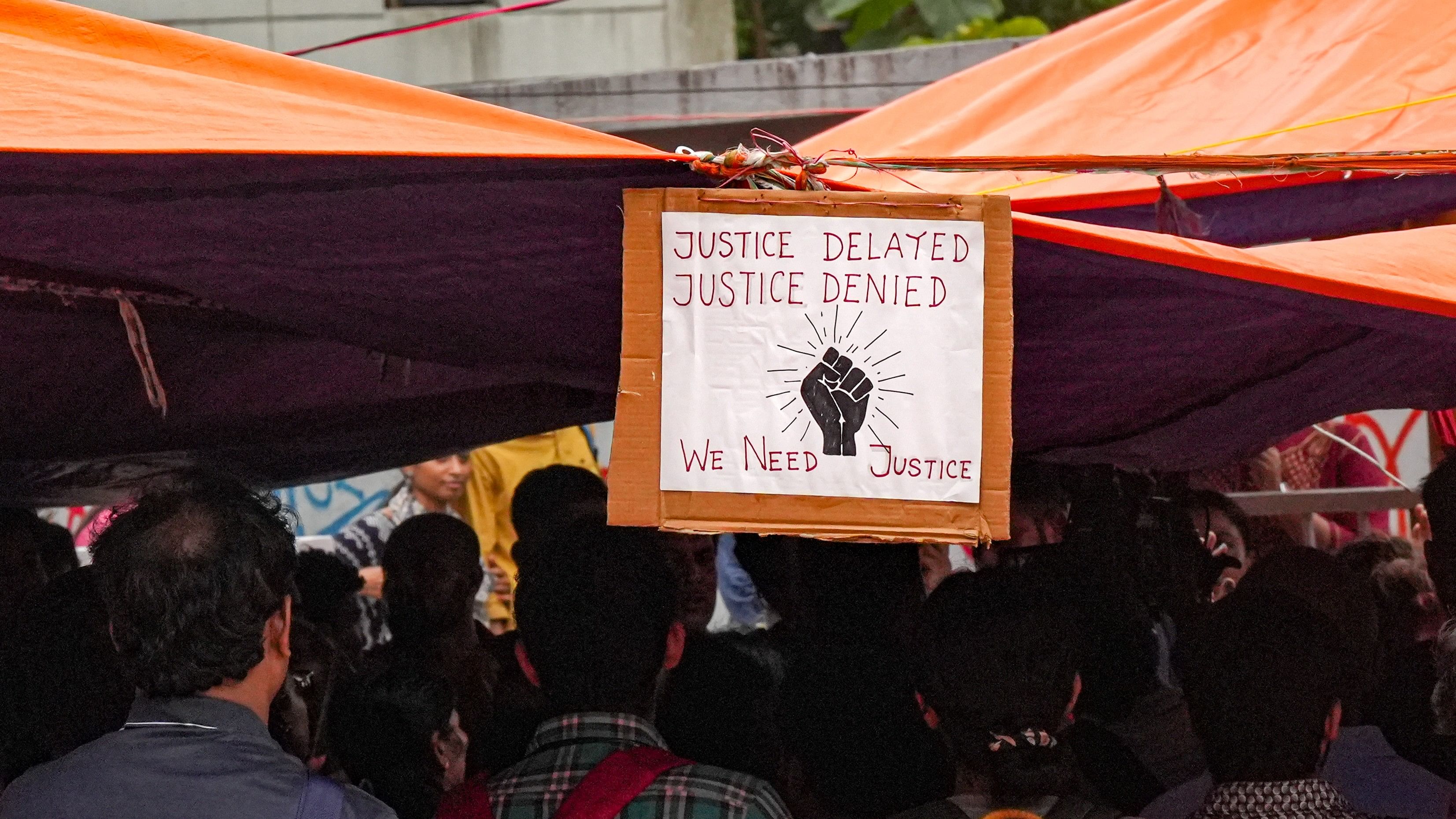 <div class="paragraphs"><p>A poster hangs at the protest site as junior doctors continue their 'cease work' and sit-in demonstration against the RG Kar Hospital incident</p></div>