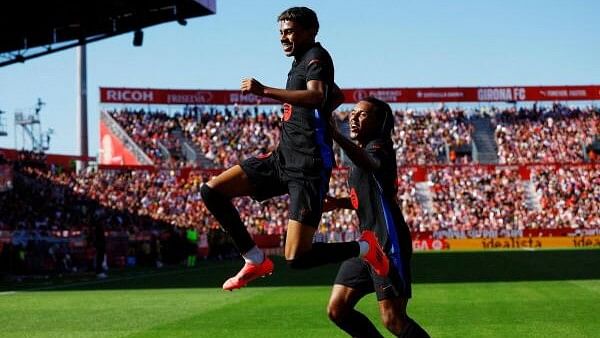 <div class="paragraphs"><p>Barcelona's Lamine Yamal celebrates scoring their first goal against Girona with teammate Jules Kounde.</p></div>