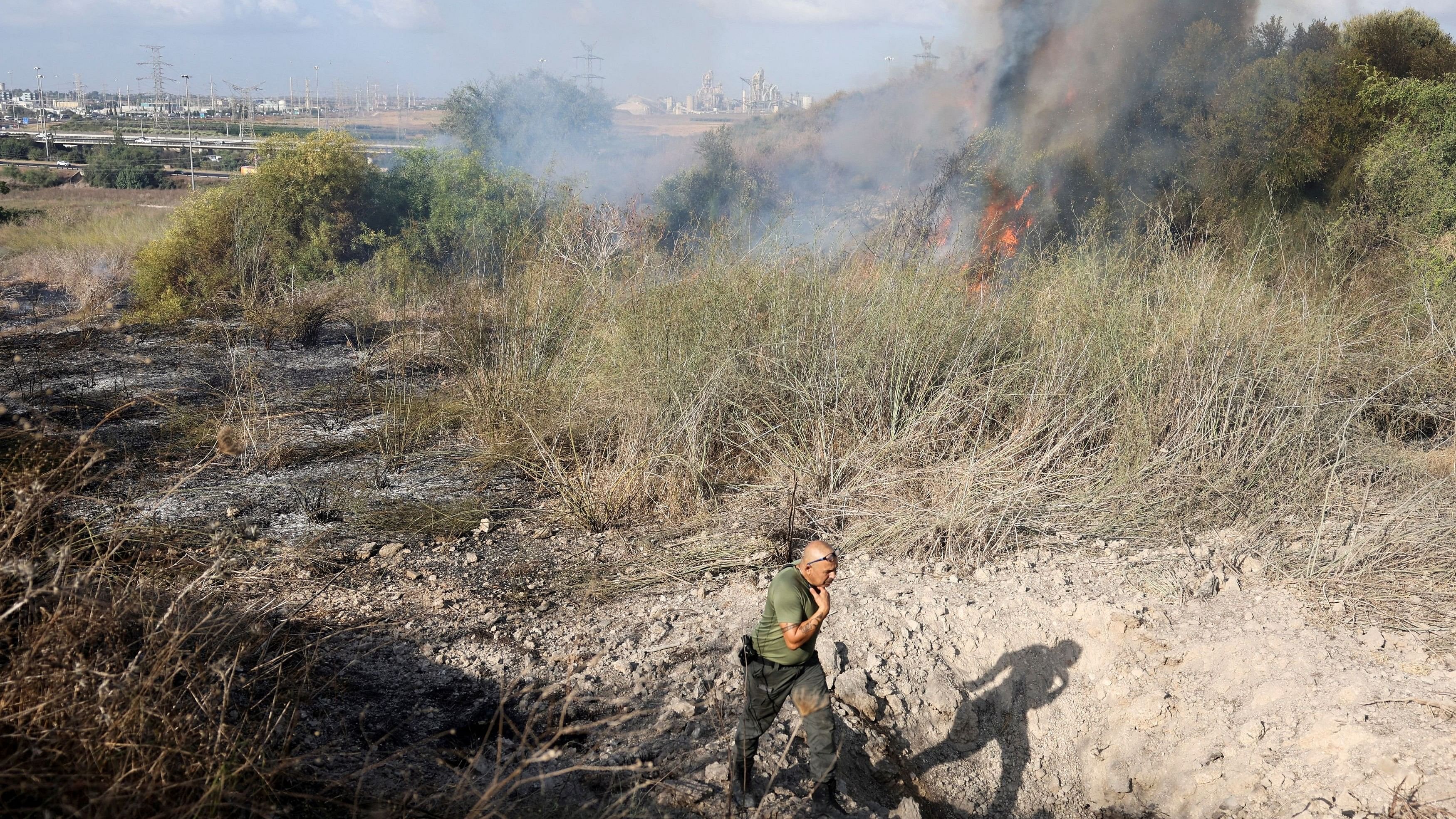 <div class="paragraphs"><p>An Israeli policeman walks next to a crater inside an impact spot following a missile attack from Yemen in central Israel.</p></div>