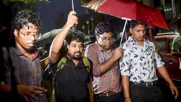 <div class="paragraphs"><p>Protesting doctors walk towards the residence of West Bengal Chief Minister Mamata Banerjee for a meeting over the alleged rape and murder of a medic at the RG Kar Medical College and Hospital, in Kolkata.&nbsp;</p></div>