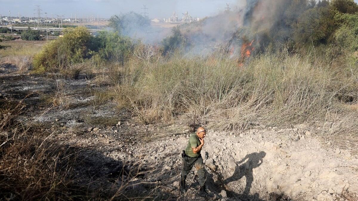 <div class="paragraphs"><p>An Israeli policeman walks next to a crater inside an impact spot following a missile attack from Yemen.</p></div>