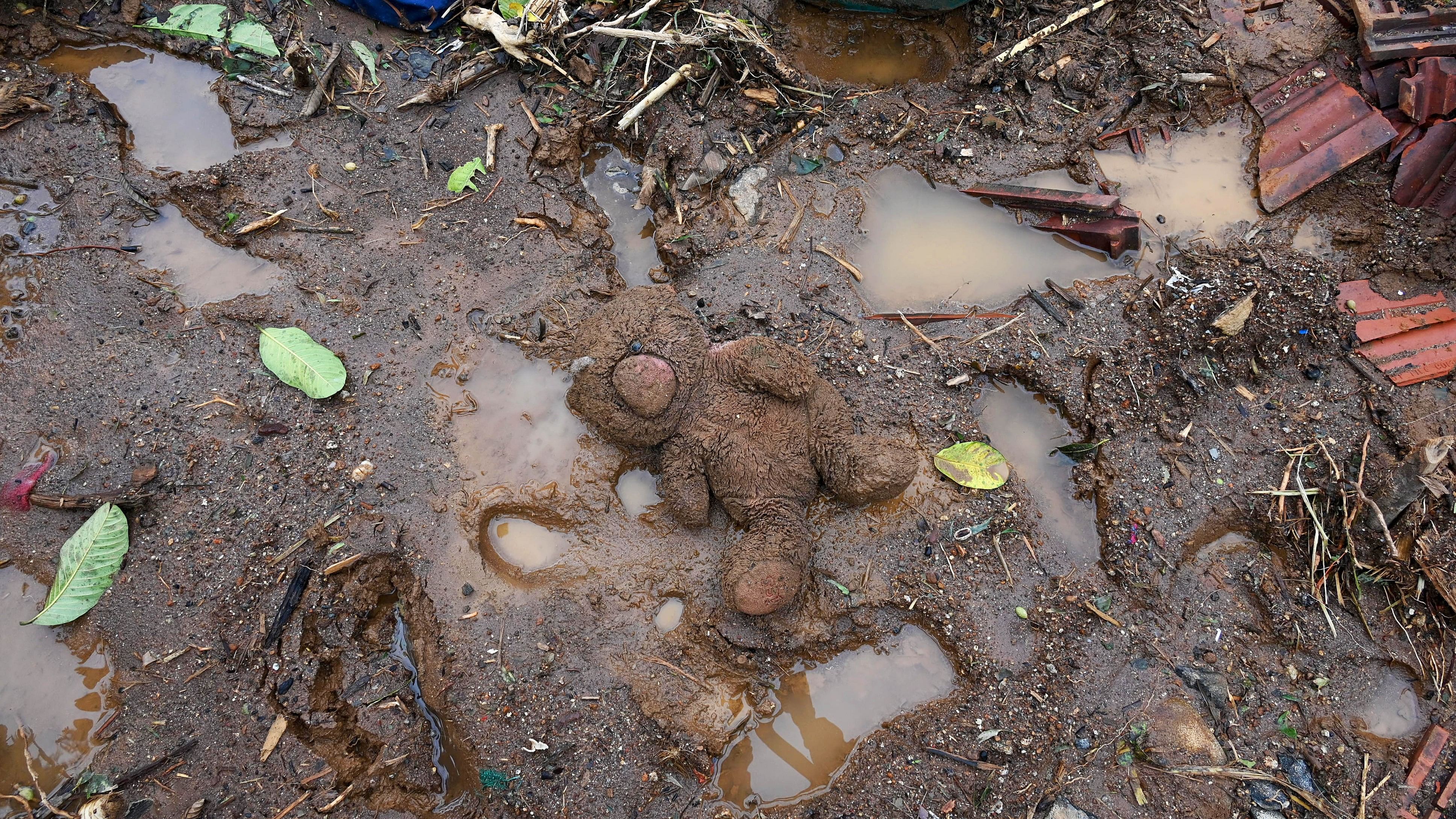 <div class="paragraphs"><p>A stuffed doll lays outside a damaged house at a settlement 3 km uphill from Mundakkai epicenter of the devastating landslide in Wayanad, on Saturday, August 3, 2024.</p></div>