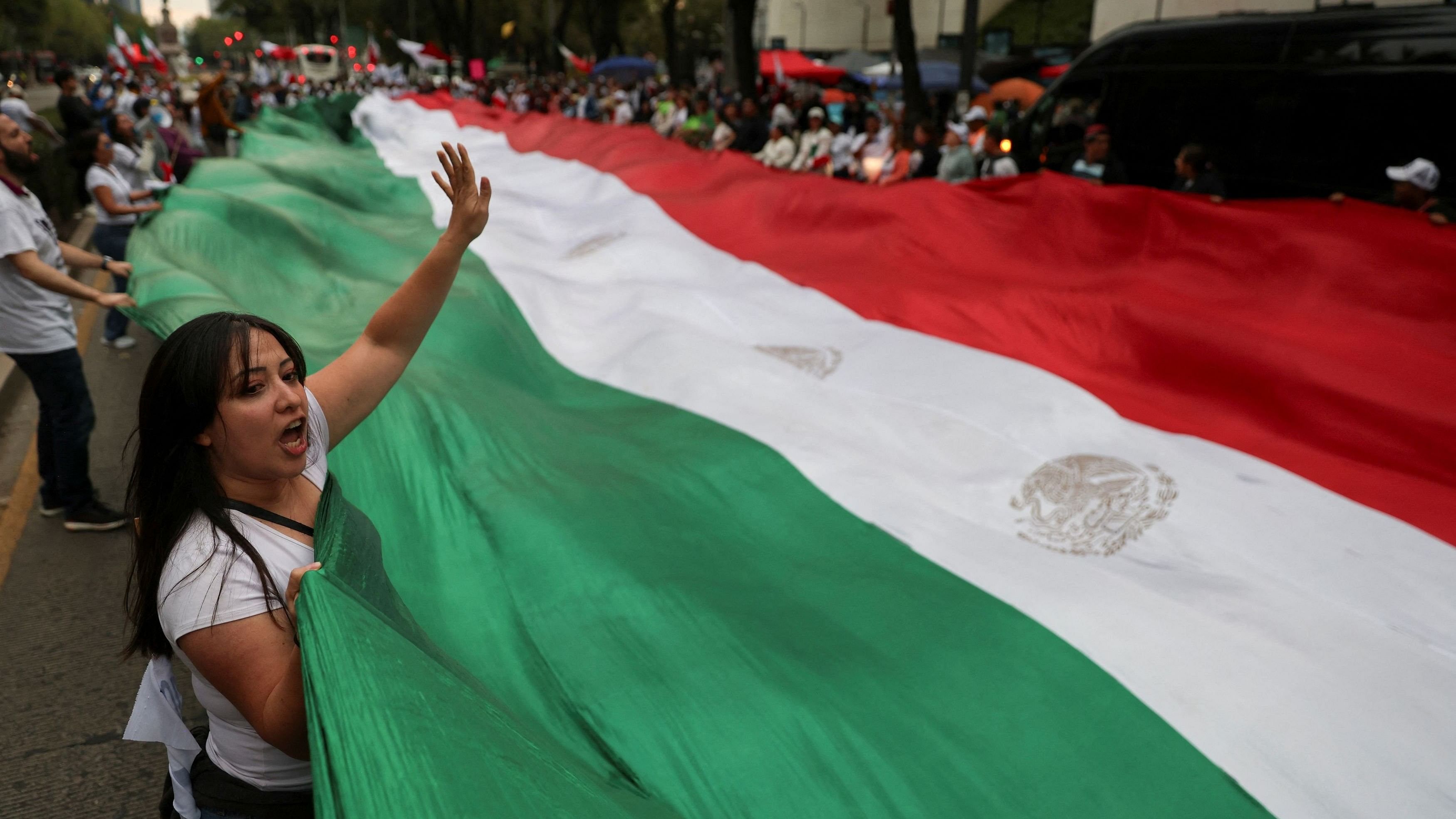 <div class="paragraphs"><p>Demonstrators display a large Mexico flag during a protest against the controversial overhaul of the country's judiciary, which would usher in a new era of elections for all judges, outside the Senate building in Mexico City, Mexico.&nbsp;</p></div>