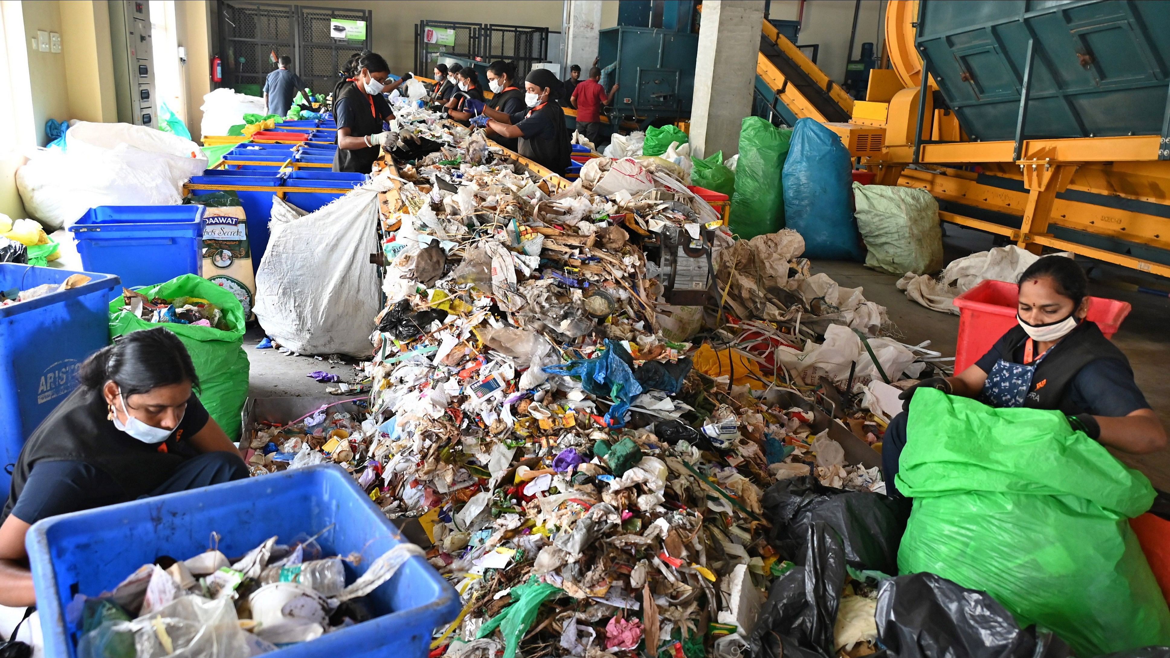 <div class="paragraphs"><p>Workers sort solid waste at a facility in the city. </p></div>