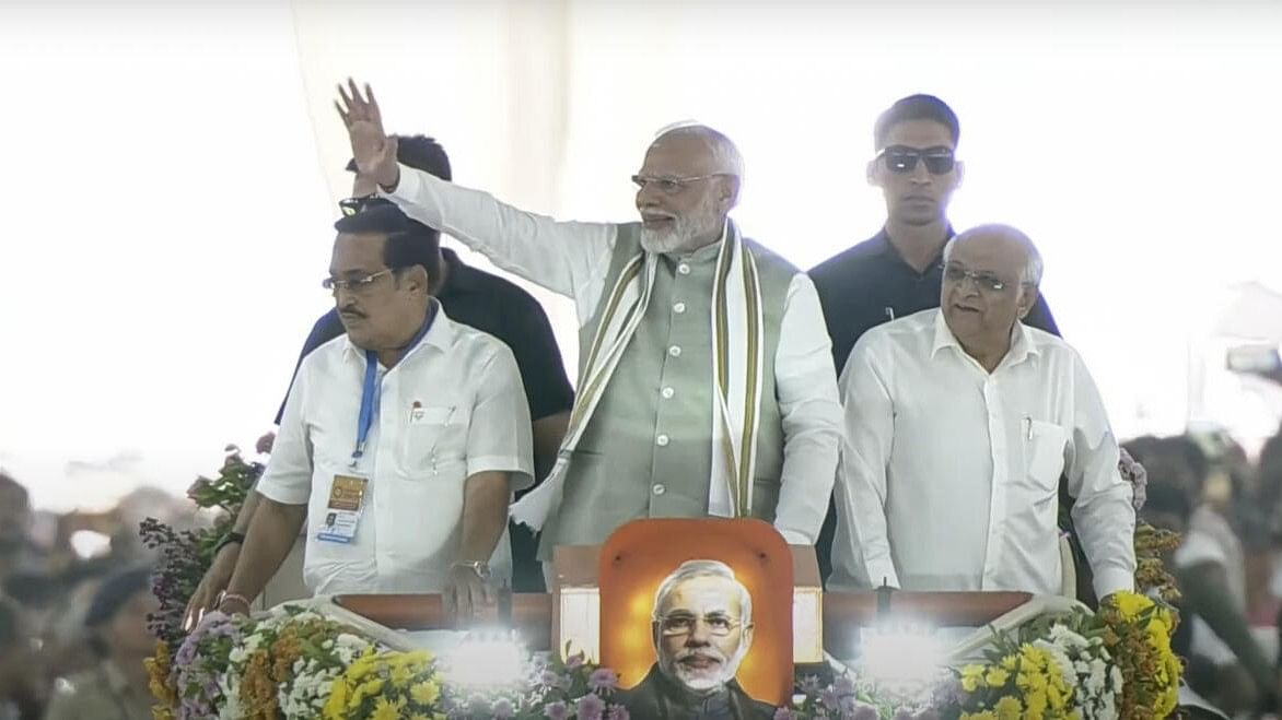 <div class="paragraphs"><p>PM Modi waves to crowd during a public meeting in Ahmedabad.&nbsp;</p></div>