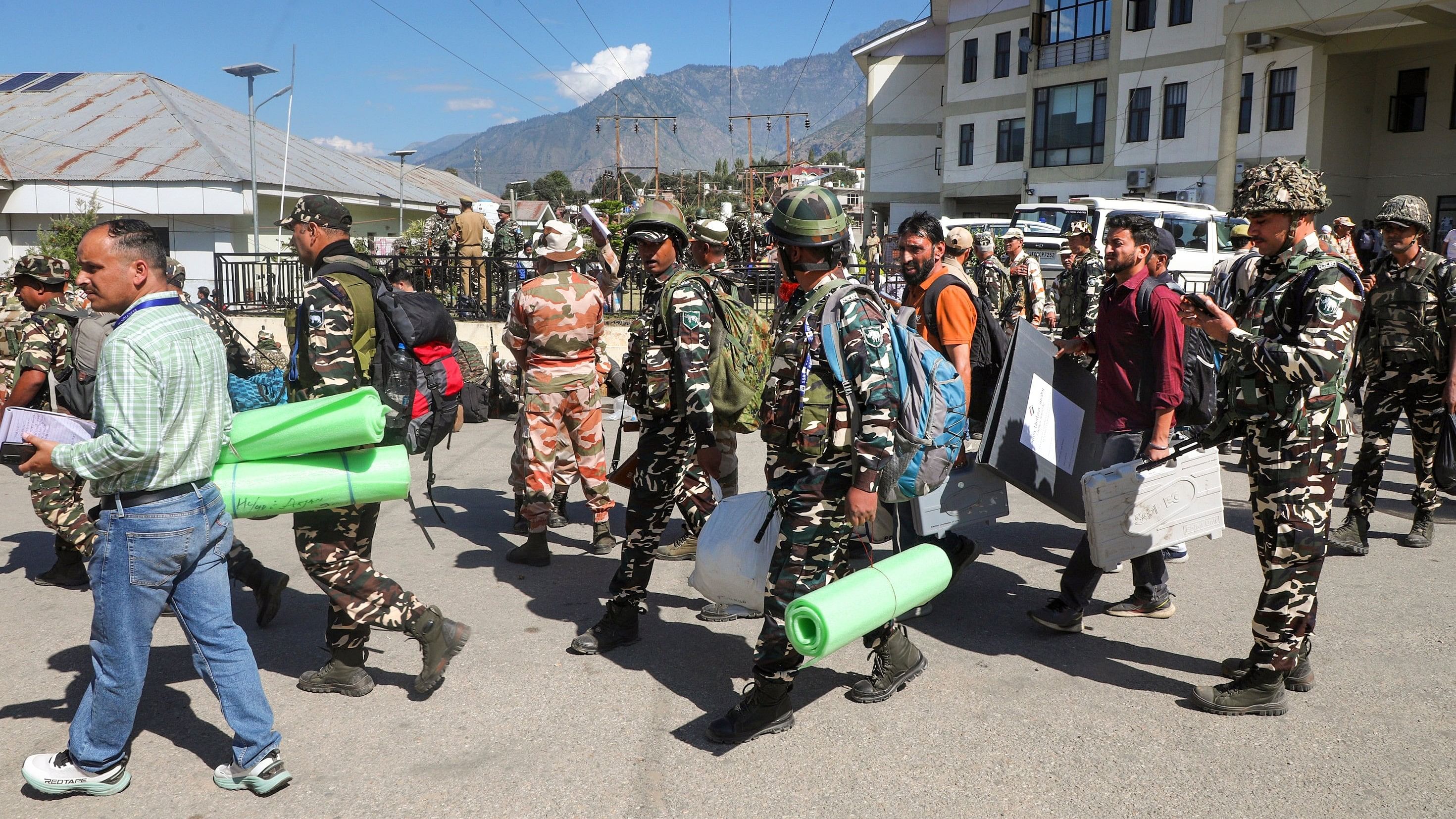 Kishtwar: Polling officials with security personnel leave for their respective polling stations on the eve of first phase of the Jammu and Kashmir Assembly election, in Kishtwar district, Tuesday, Sept. 17, 2024. (PTI Photo) (PTI09_17_2024_000107B)