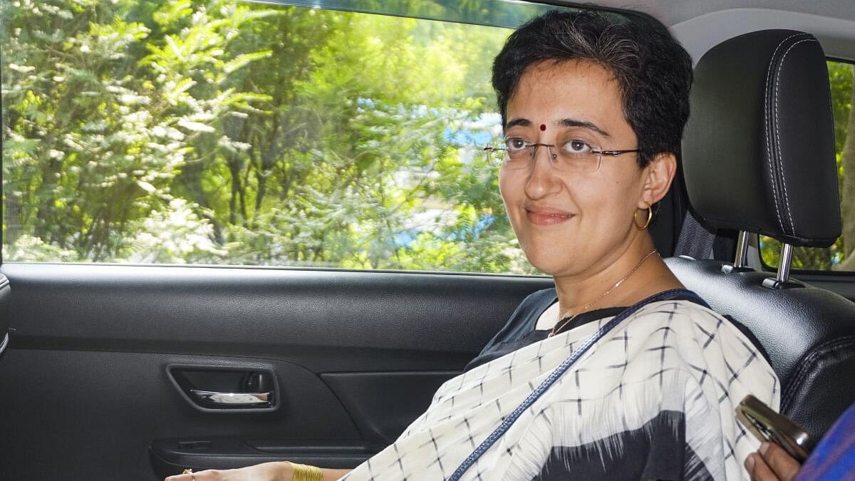 <div class="paragraphs"><p>Delhi Minister and AAP leader Atishi leaves after a meeting of the legislative party at Chief Minister Arvind Kejriwal's residence, in New Delhi.</p></div>