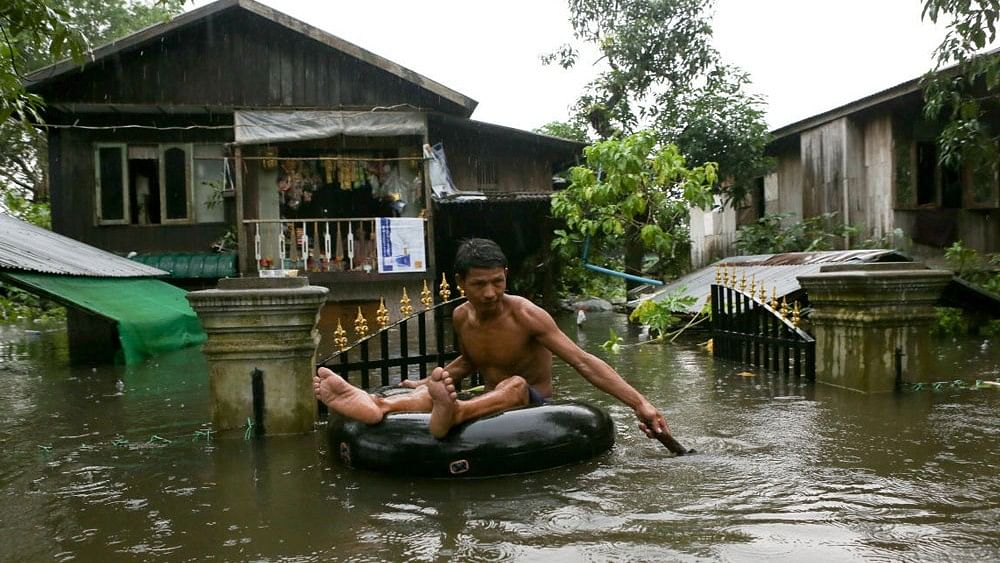 <div class="paragraphs"><p>A man travels through a flooded street in  Myanmar. </p></div>