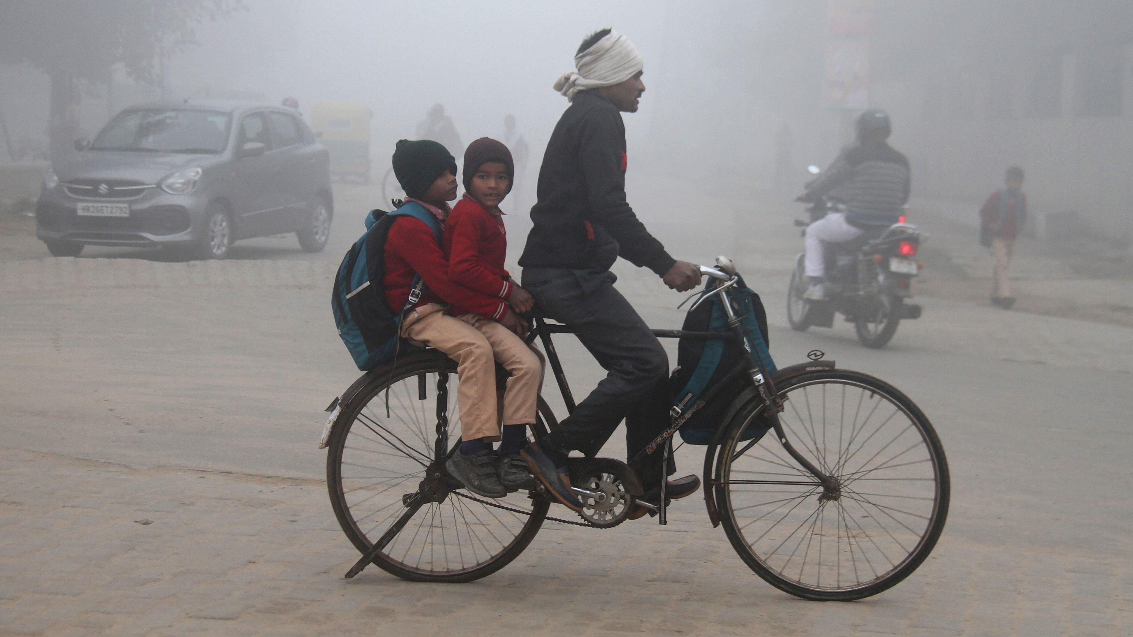 <div class="paragraphs"><p>Gurugram: Children head to school on a bicycle during a foggy winter morning, in Gurugram, Wednesday, Dec. 27, 2023. </p></div>