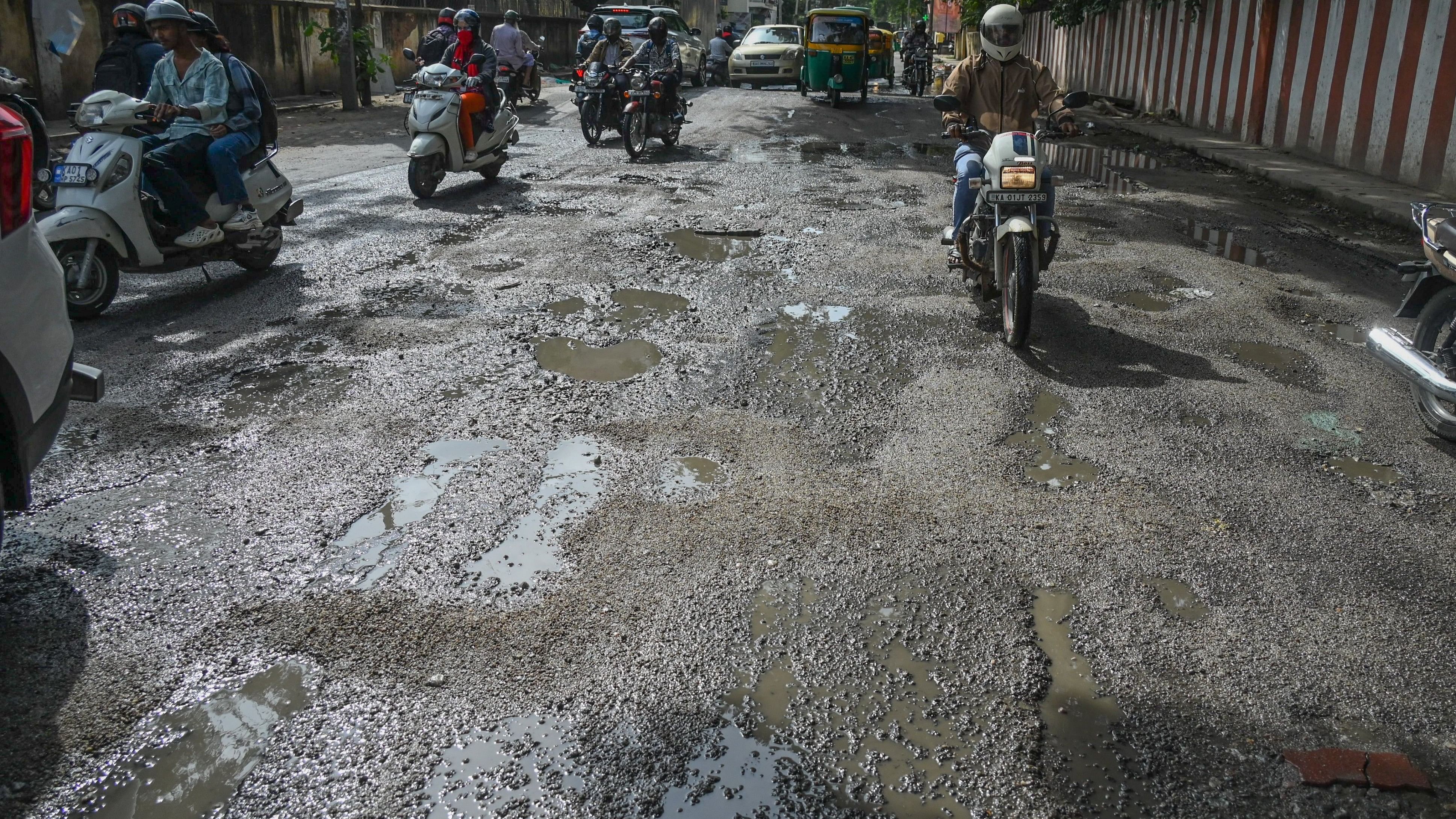 <div class="paragraphs"><p>A stretch at Hombegowda Nagar main road is dotted with numerous potholes. </p></div>