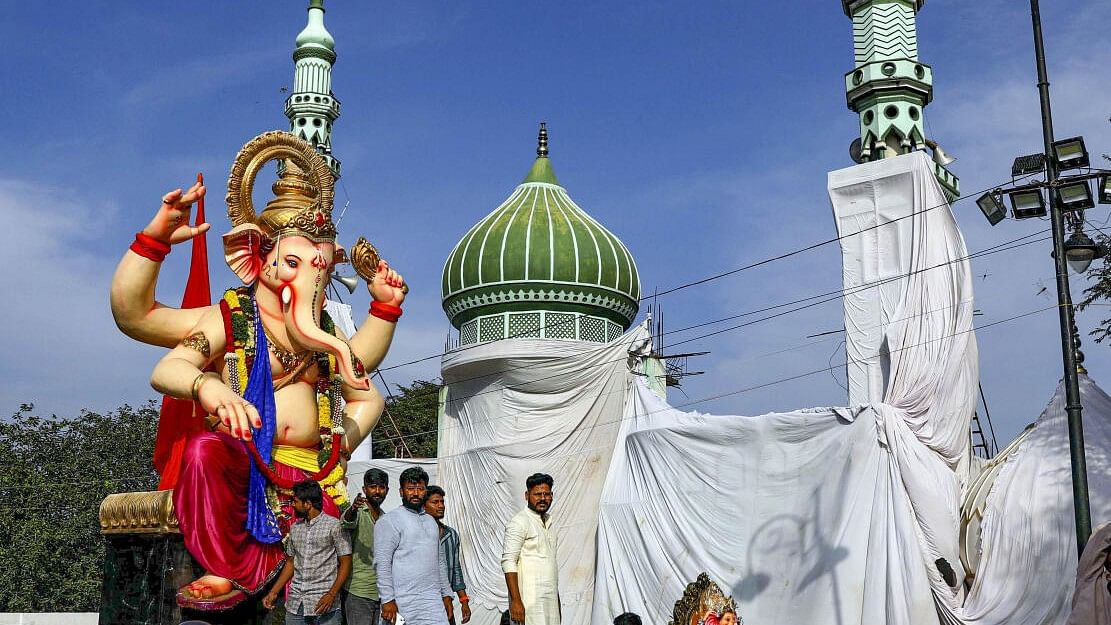 <div class="paragraphs"><p>Devotees carry a huge Ganesh idol on a tractor to immerse in Tank Bund at a mosque covered with a cloth on the Milad-e-Un Nabi festival, in Hyderabad, Monday, Sept. 16, 2024.</p></div>