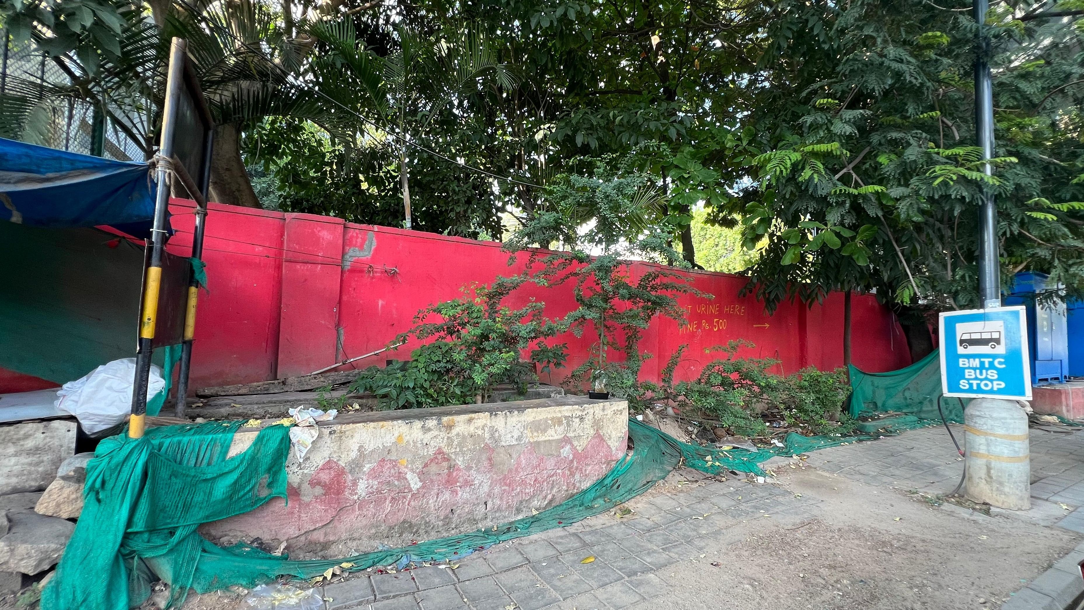 This bus stop on M G Road can be identified only by a small blue board tied to a street light nearby