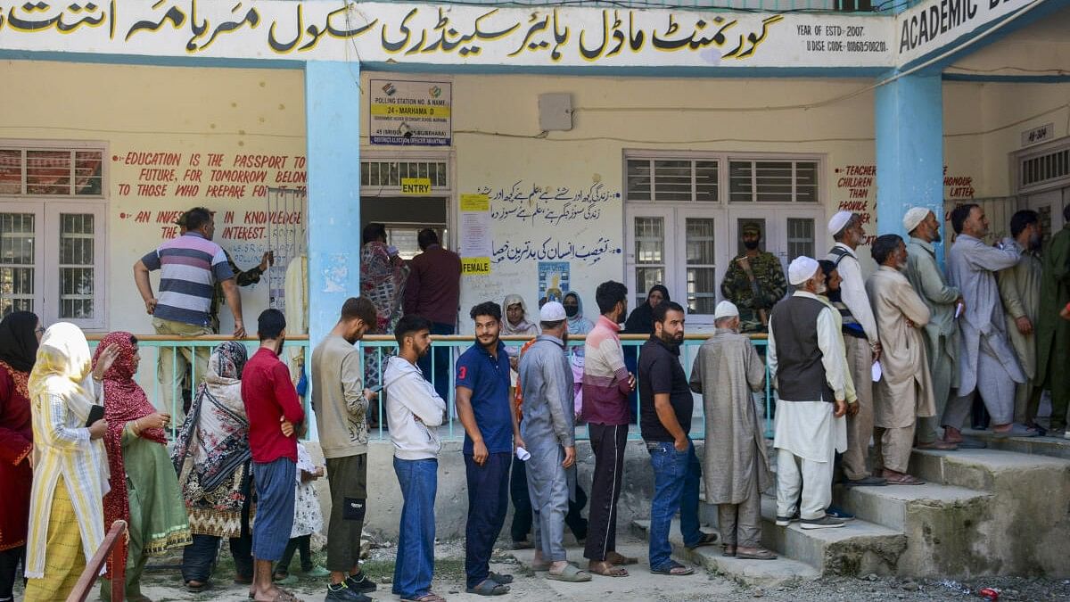 <div class="paragraphs"><p>Voters stand in a queue to cast votes at a polling station during the first phase of Kashmir Assembly elections.</p></div>