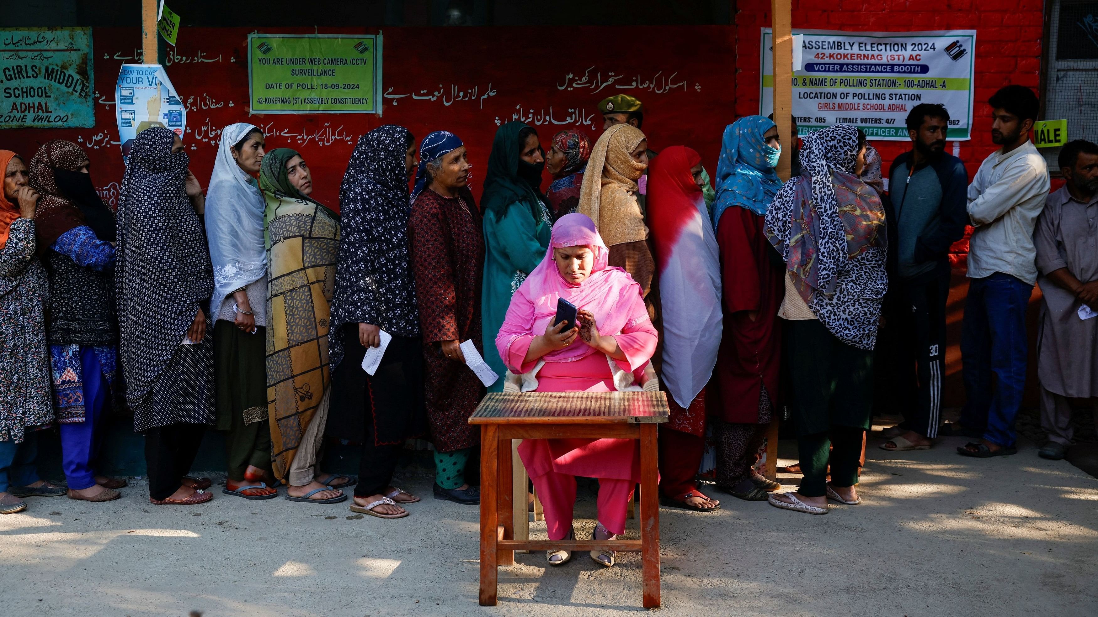 <div class="paragraphs"><p>Kashmiri women stand in a queue to vote at a polling station, during the first phase of assembly election, in south Kashmir's Kokernag.</p></div>