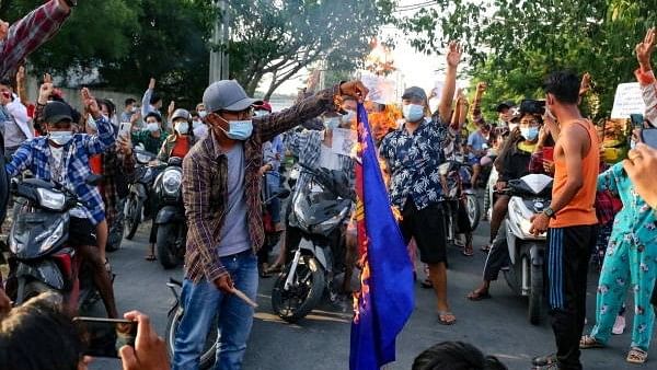 <div class="paragraphs"><p>Protesters against Myanmar's junta burn the flag of the Association of Southeast Asian Nations (ASEAN), in Mandalay, Myanmar.</p></div>