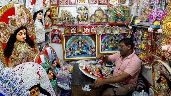 <div class="paragraphs"><p>Artisan paints a decorative of the Hindu goddess Durga inside a shop ahead of the Durga Puja festival in Kolkata.</p></div>