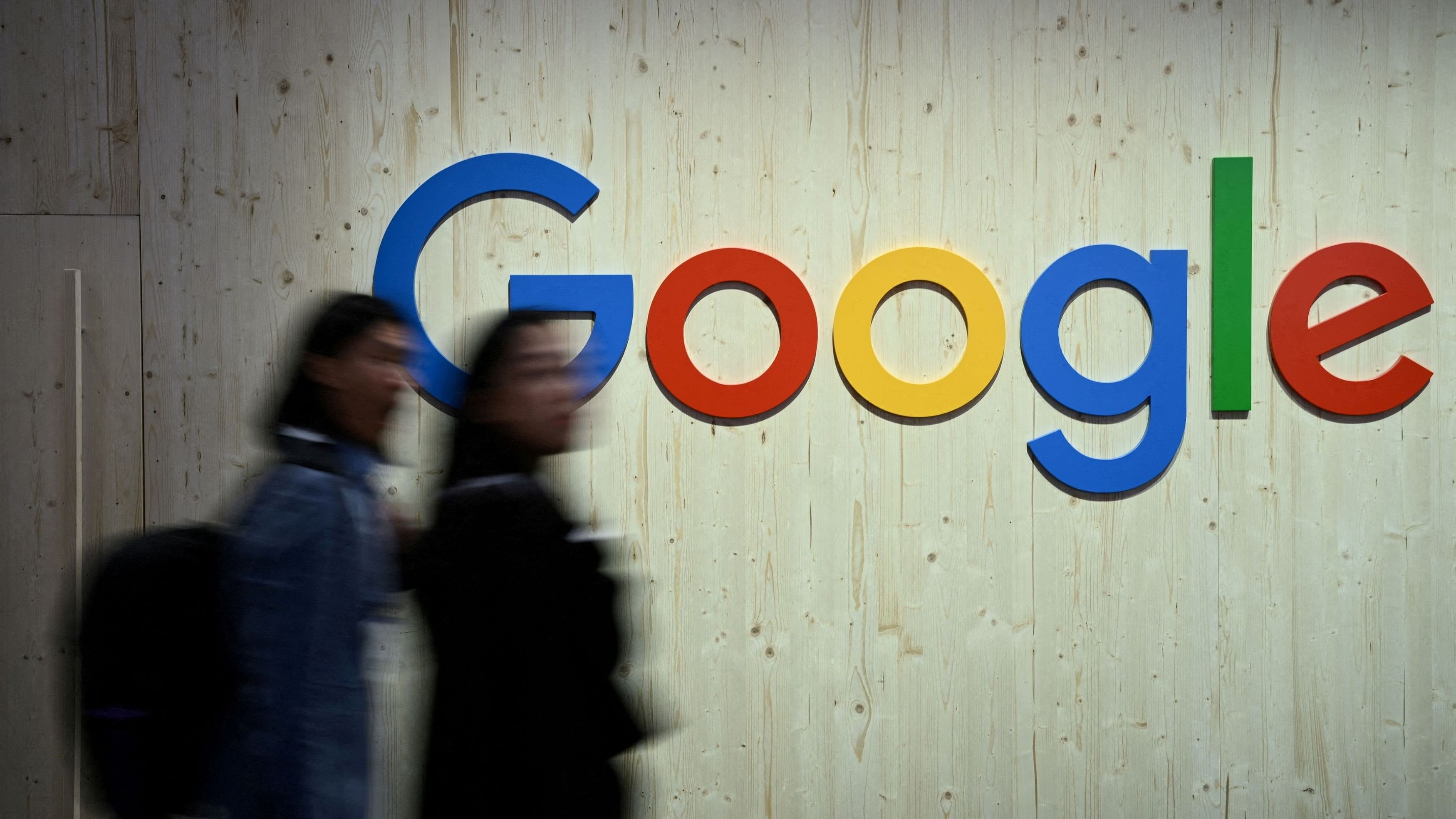 <div class="paragraphs"><p>People walk next to a Google logo during a trade fair in Hannover Messe, in Hanover, Germany.</p></div>