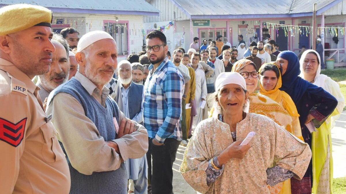 <div class="paragraphs"><p>oters stand in a queue to cast votes during the first phase of Jammu and Kashmir Assembly elections, in Pulwama district. </p></div>