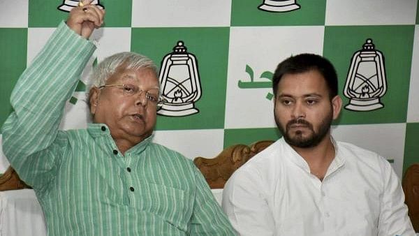 <div class="paragraphs"><p>Former railway minister Lalu Prasad (L) and his son  Tejashwi Yadav (R).</p></div>