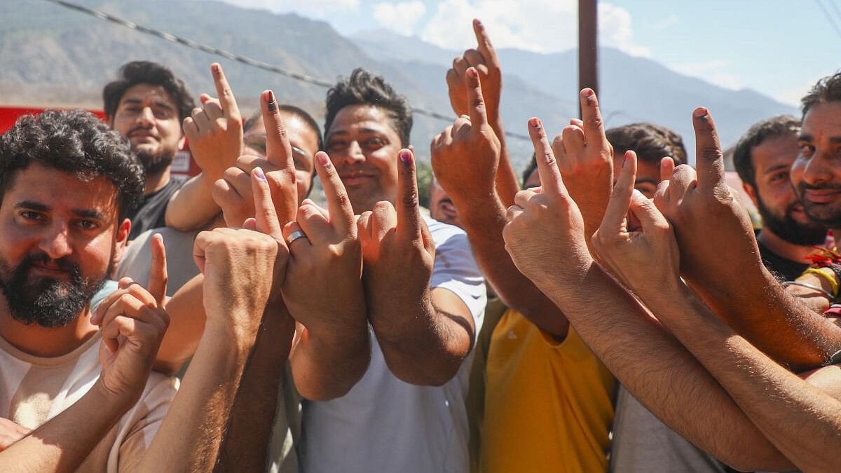 <div class="paragraphs"><p>Voters show their fingers marked with indelible ink after casting votes during the first phase of Jammu and Kashmir Assembly elections, in Kishtwar, Wednesday, September 18, 2024.</p></div>