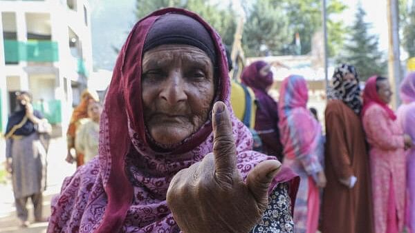 <div class="paragraphs"><p>An elderly voter shows her finger marked with indelible ink after casting votes during the first phase of Jammu and Kashmir Assembly elections, in Kishtwar district.</p></div>