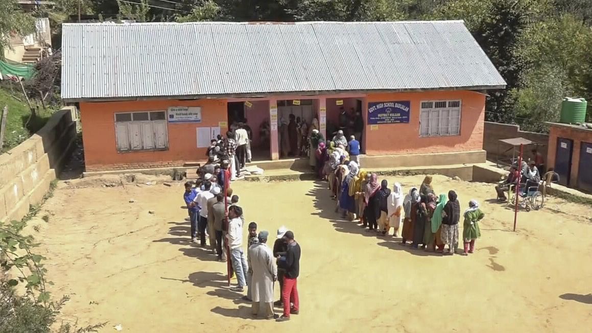 <div class="paragraphs"><p>Voters stand in queues to cast votes at a polling station during the first phase of Jammu and Kashmir Assembly elections, in Kulgam district.</p></div>