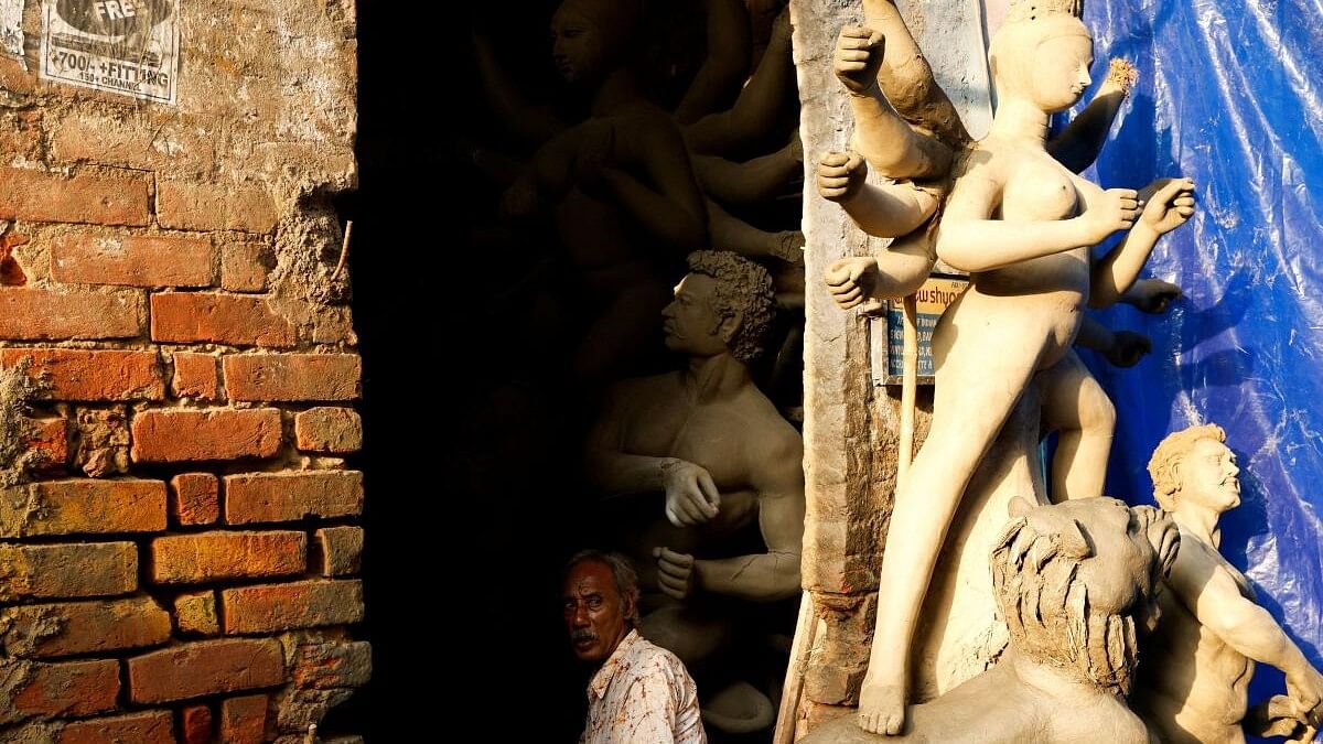 <div class="paragraphs"><p>An artisan takes a break from preparing idols of the Hindu goddess Durga at a workshop ahead of the Durga Puja festival in Kolkata</p></div>