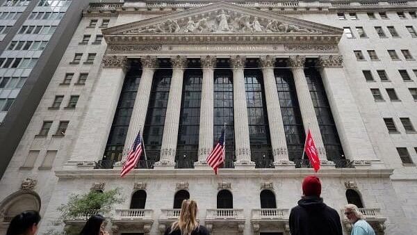 <div class="paragraphs"><p>People look toward the New York Stock Exchange (NYSE) before the Federal Reserve announcement in New York City, US.</p></div>