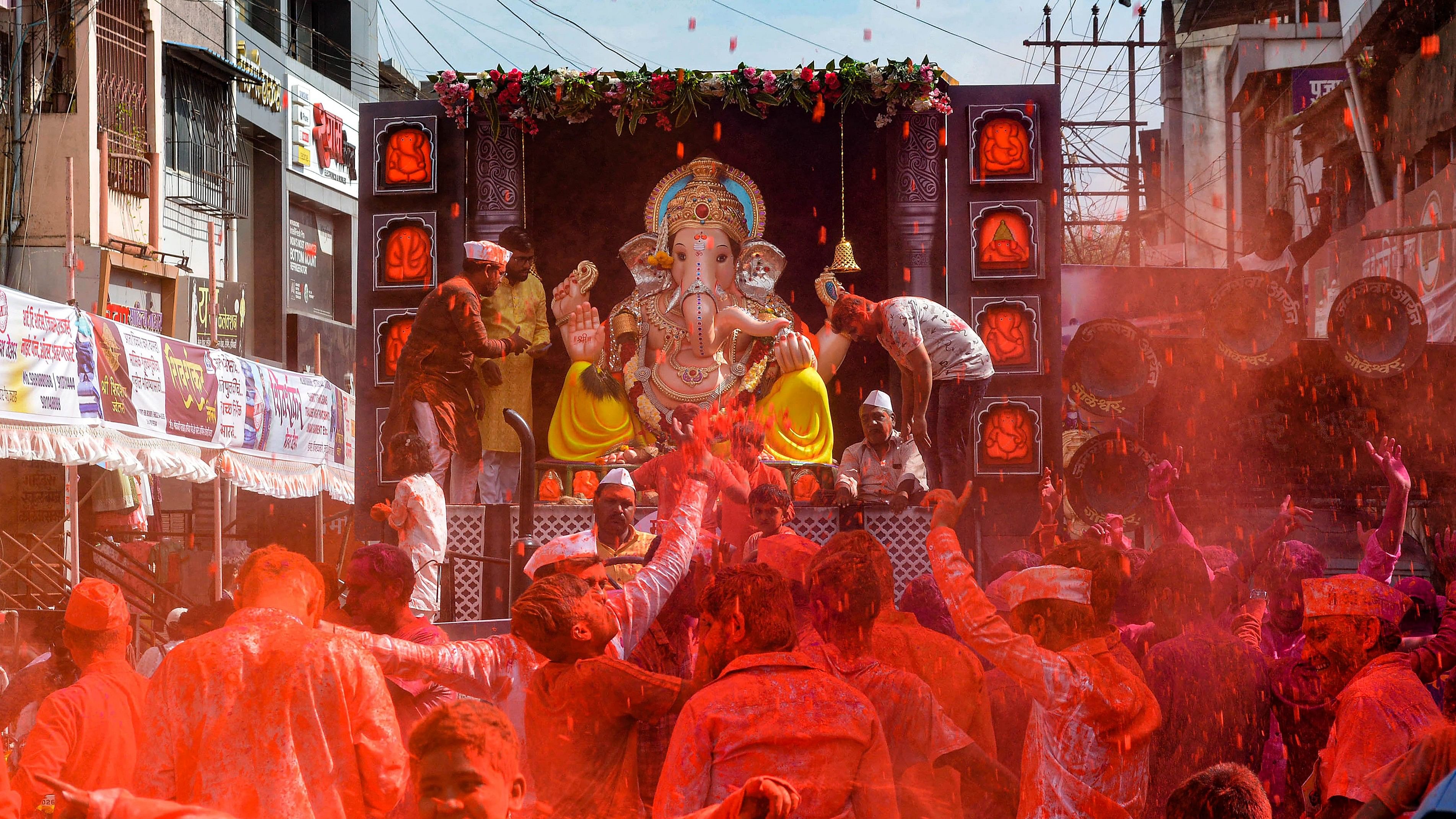 <div class="paragraphs"><p>Devotees throw colours in celebration during a procession of Lord Ganesha for immersion during the conclusion of the Ganesh Chaturthi festival, in Maharashtra.</p></div>