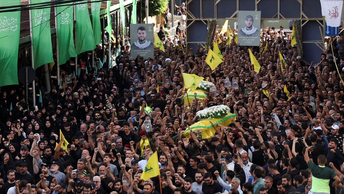 <div class="paragraphs"><p>Mourners carry the coffins of Hezbollah members after hand-held radios and pagers detonated across Lebanon.</p></div>