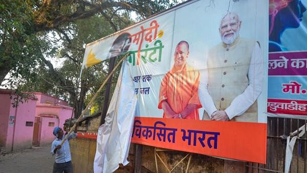 <div class="paragraphs"><p>A worker removes posters of political leaders after the Model Code of Conduct was enforced following the announcement of the schedule of Lok Sabha elections.</p></div>