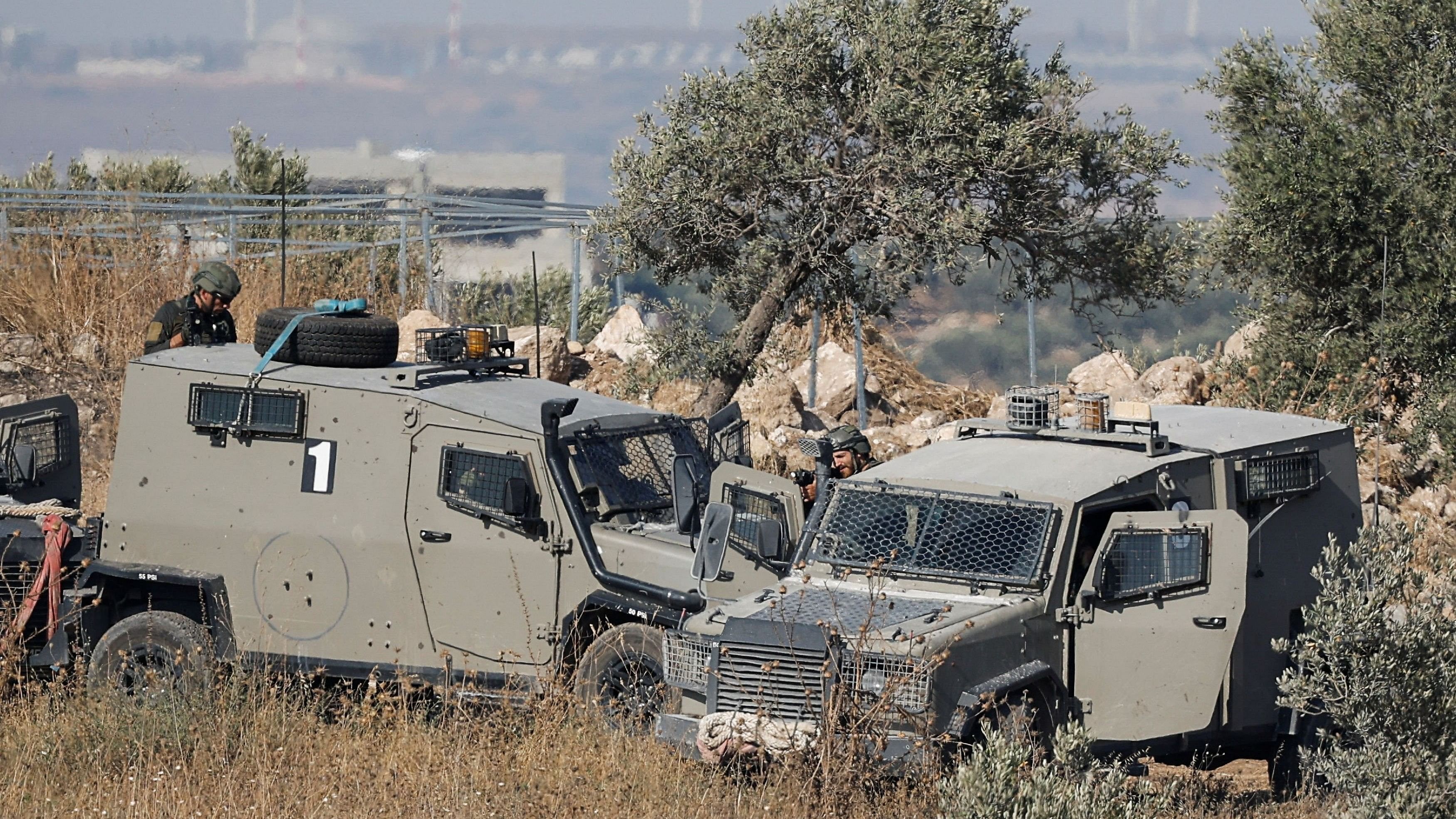 <div class="paragraphs"><p>Israeli forces take positions behind vehicles, during a military operation,  in the Israeli-occupied West Bank.</p></div>