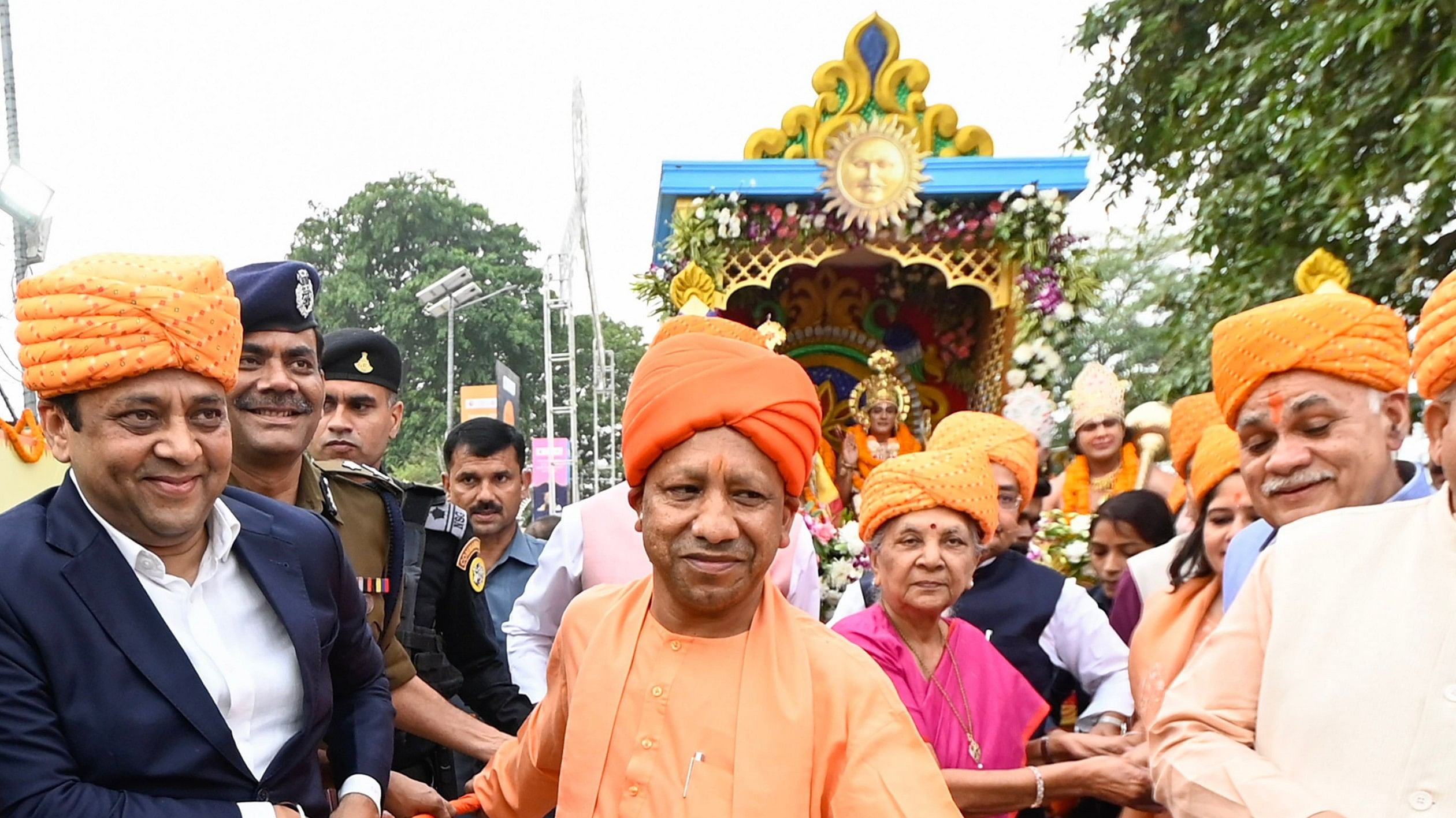 <div class="paragraphs"><p> Chief Minister Yogi Adityanath and others pulls the chariot carrying artists dressed as Lord Rama, Lakshman and goddess Sita during 'Deepotsav' celebrations, in Ayodhya, Saturday, Nov. 11, 2023. Representative image</p></div>