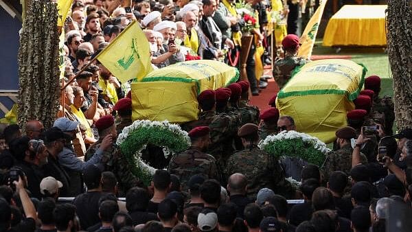 <div class="paragraphs"><p>Mourners gather near the coffins of Hezbollah members Fadel Abbas Bazzi and Ahmad Ali Hassan, after hand-held radios and pagers used by armed group Hezbollah detonated across Lebanon, during their funeral in Ghobeiry, Beirut southern suburbs, Lebanon September 19, 2024. </p></div>