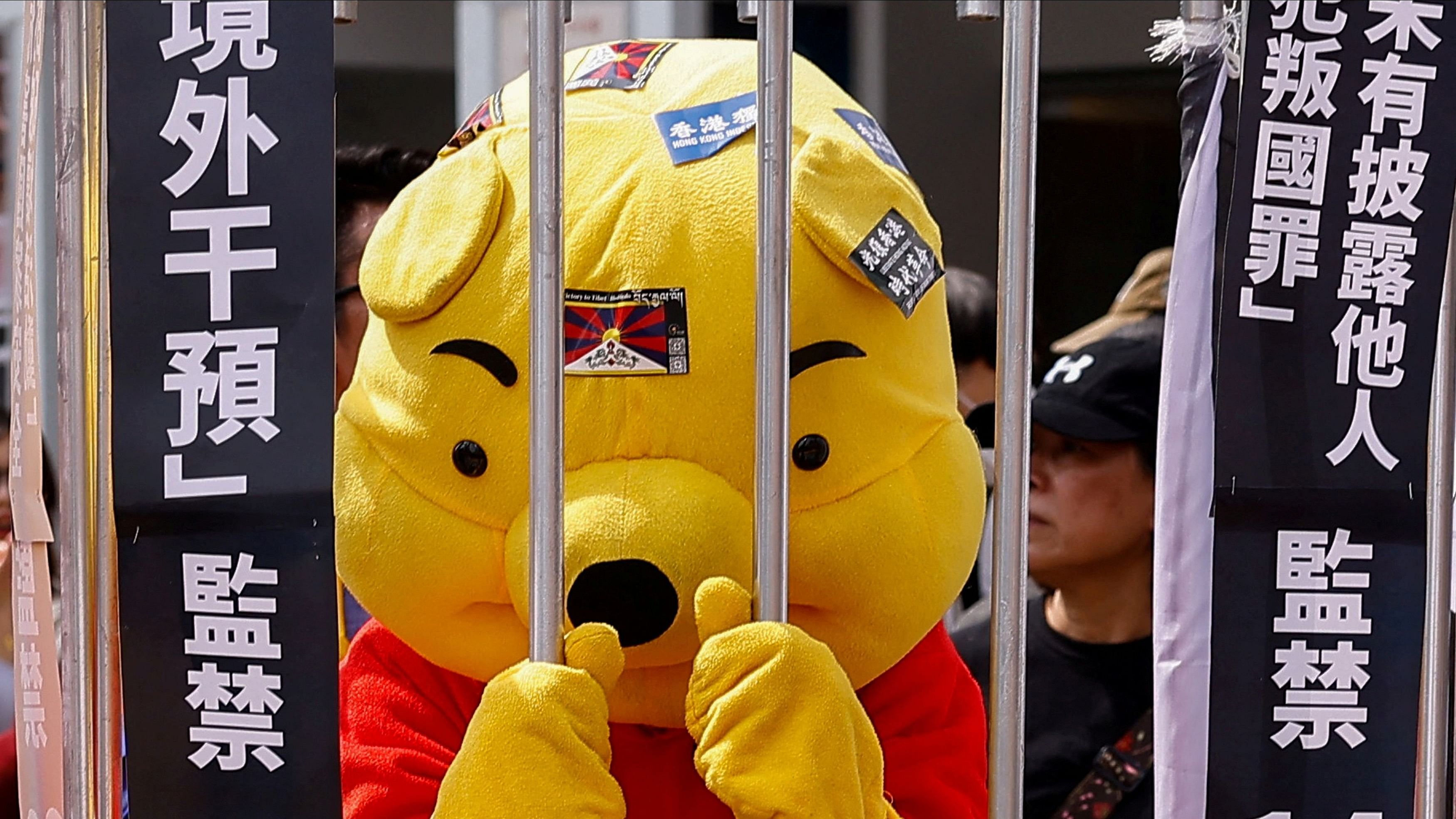 <div class="paragraphs"><p>A person dressed as Winnie the Pooh stands behind a makeshift jail at a global protest against Hong Kong's new Article 23 national security law in Taipei, Taiwan March 23, 2024. </p></div>