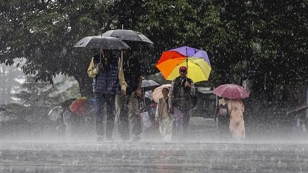 <div class="paragraphs"><p>People amid monsoon rains, in Shimla.</p></div>