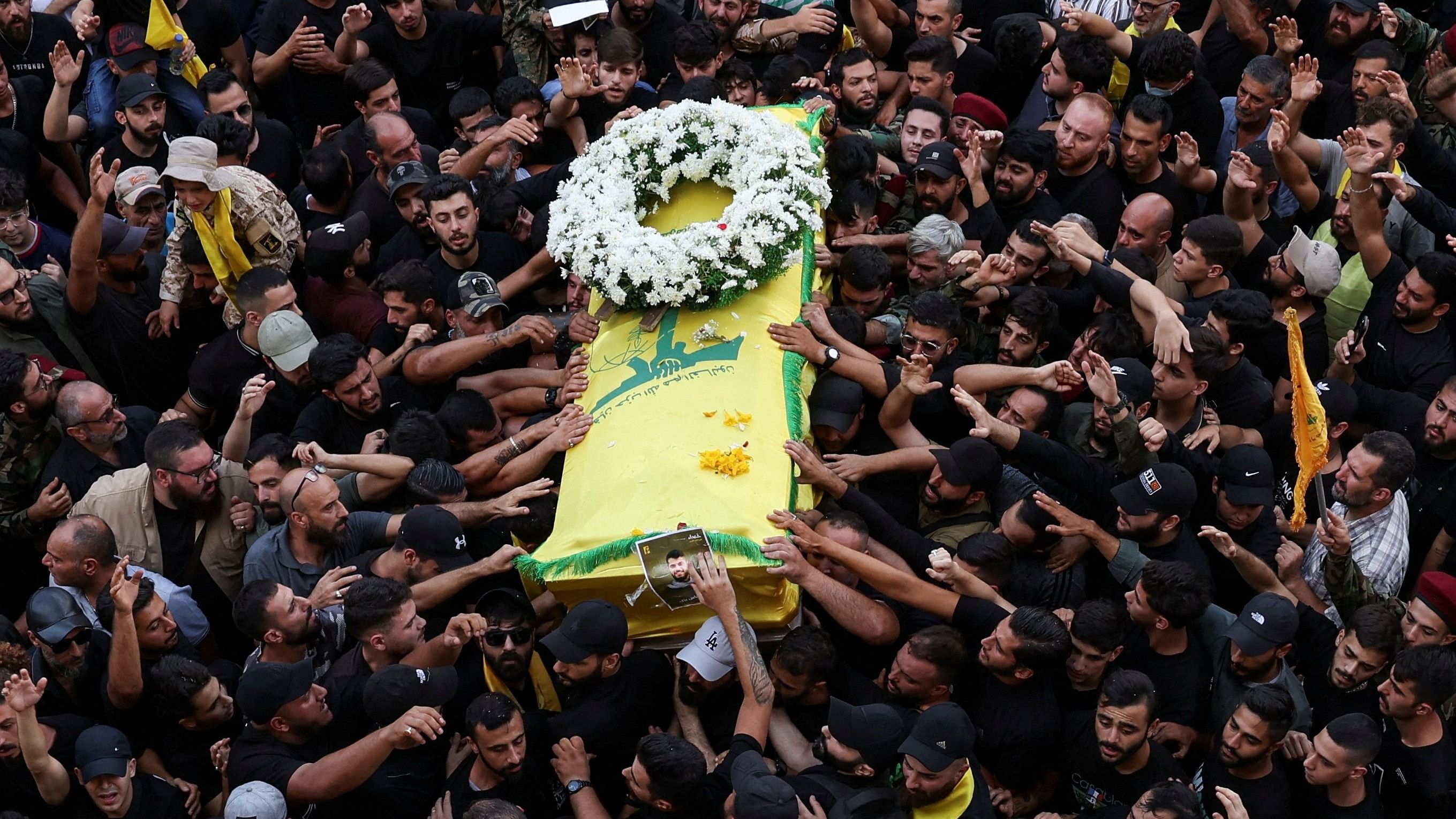 <div class="paragraphs"><p>Mourners gather at the funeral of Hezbollah members Fadel Abbas Bazzi and Ahmad Ali Hassan, after hand-held radios and pagers used by armed group Hezbollah detonated across Lebanon, in Ghobeiry, Beirut southern suburbs, Lebanon September 19, 2024. </p></div>