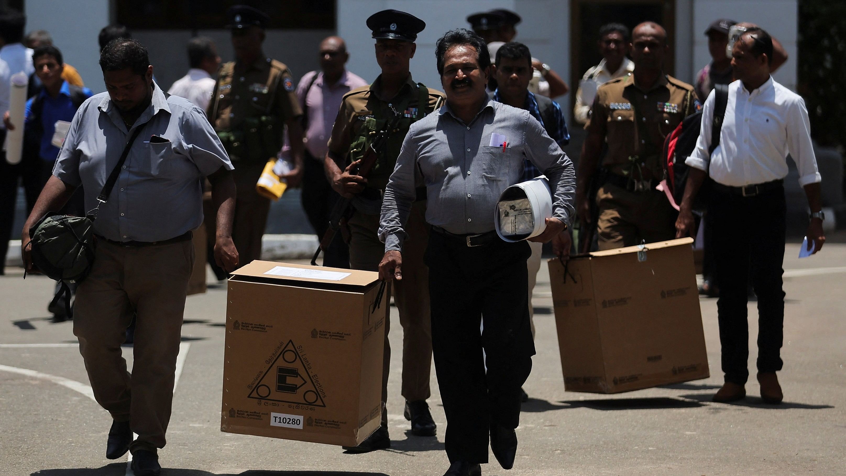 <div class="paragraphs"><p>Sri Lankan police and election officials load ballot boxes and papers into buses from a distribution center to polling stations, ahead of the upcoming presidential election, scheduled for September 21, in Colombo, Sri Lanka September 20, 2024.</p></div>