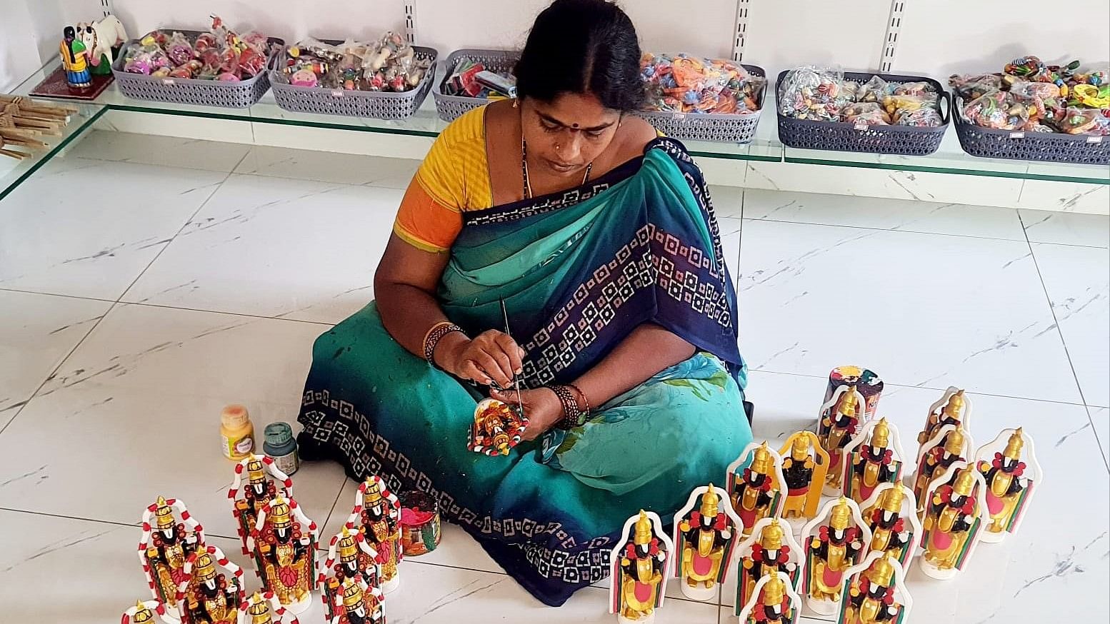 C H Rama Devi giving finishing touches to a few Venkateshwara dolls.