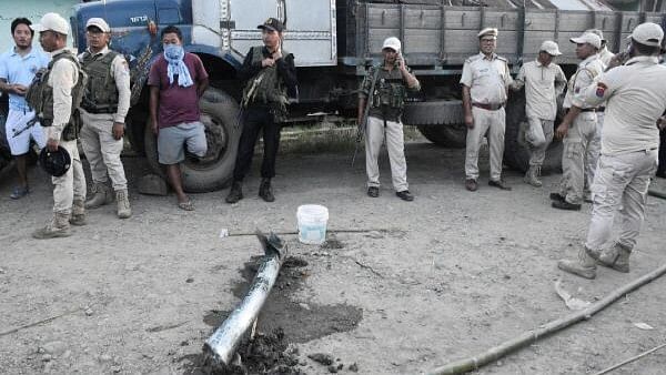 <div class="paragraphs"><p>Police personnel and locals stand near the remains of a missile after it struck in Moirang, Manipur, India, September 6, 2024.</p></div>