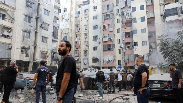 <div class="paragraphs"><p>People inspect the site of an Israeli strike in the southern suburbs of Beirut, Lebanon, September 20, 2024.</p></div>