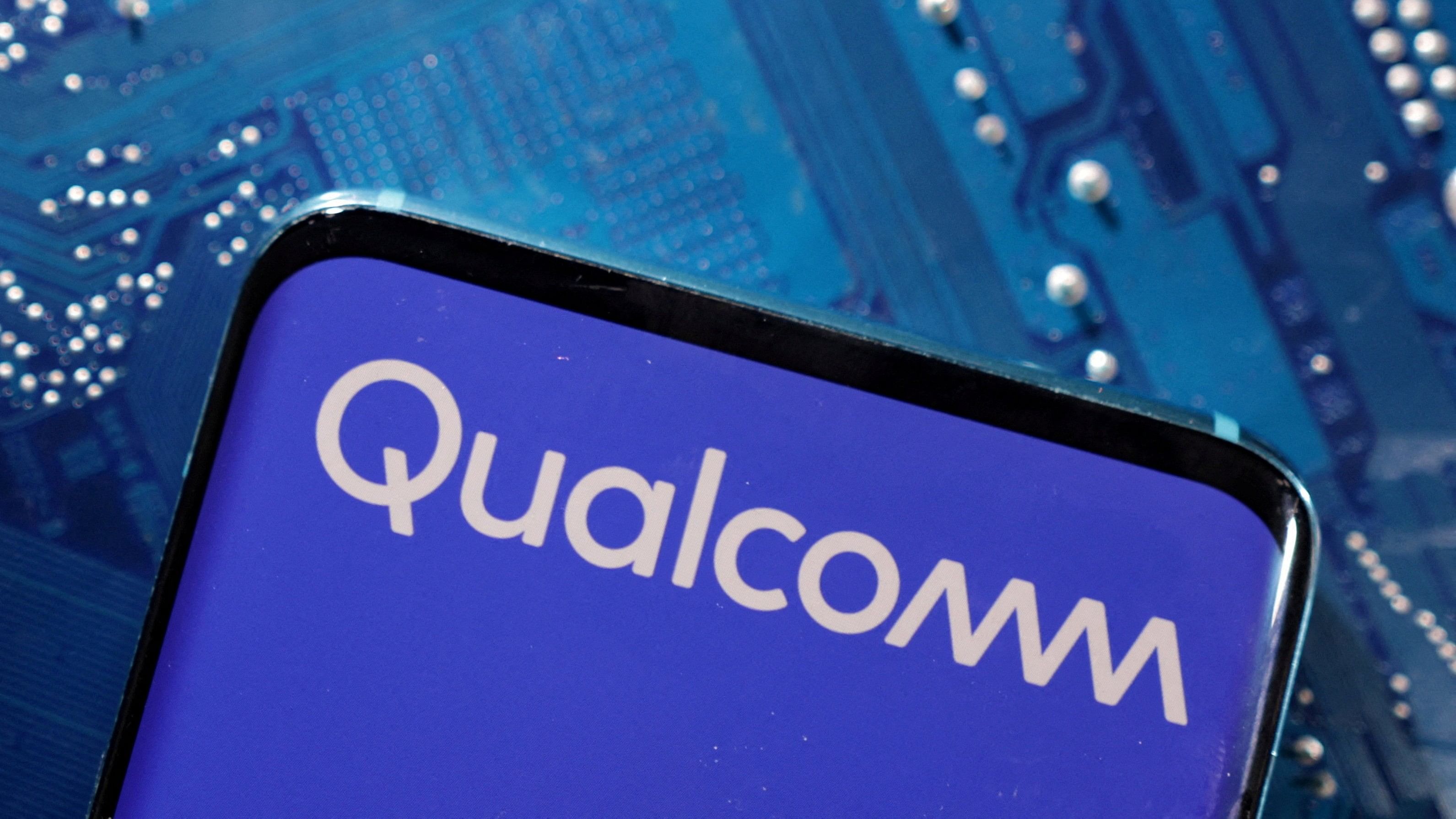 <div class="paragraphs"><p>A smartphone with a displayed Qualcomm logo is placed on a computer motherboard in this illustration.</p></div>