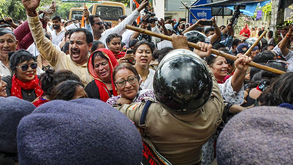 <div class="paragraphs"><p>Police personnel stop Uttarakhand Mahila Congress supporters during a protest march against alleged attrocities against women and deteriorating law and order situation, in Dehradun.</p></div>