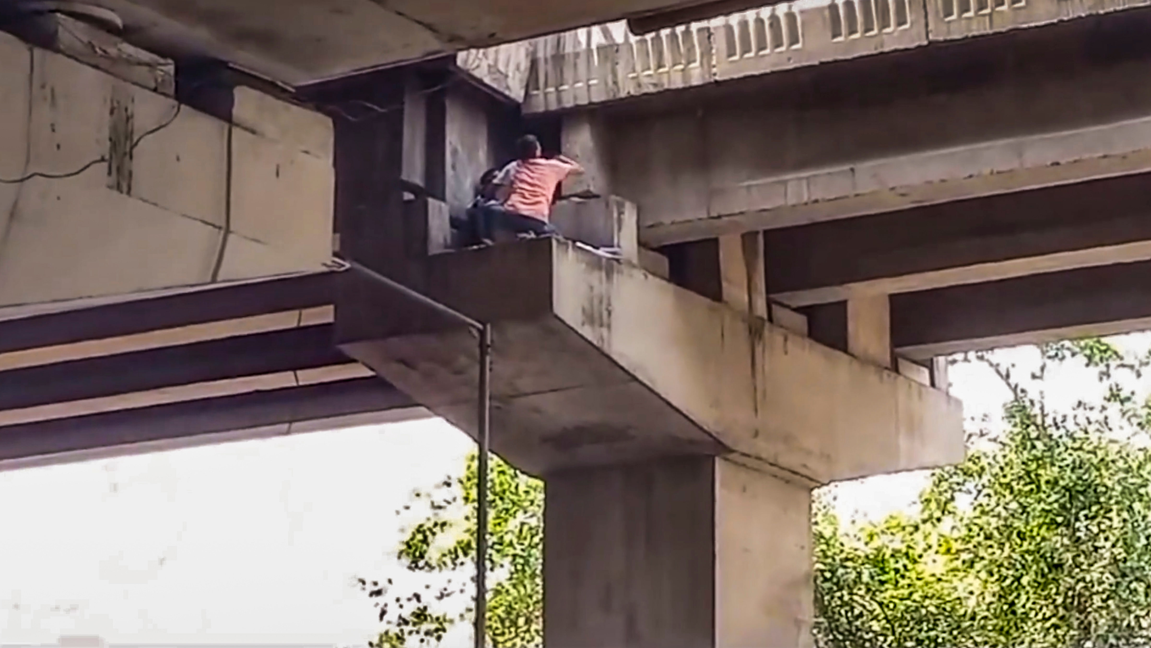 <div class="paragraphs"><p> A young woman that got stuck on the pillar of a flyover being rescued, in Noida, Saturday, Sept. 21, 2024. </p></div>