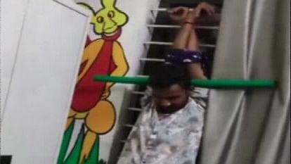 <div class="paragraphs"><p>Screengrab of tea seller tied to the window</p></div>